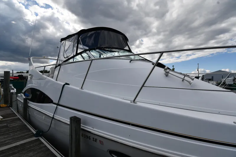 Slide: The Image of 2001 Carver 350 Mariner yacht docked under cloudy sky. - 2