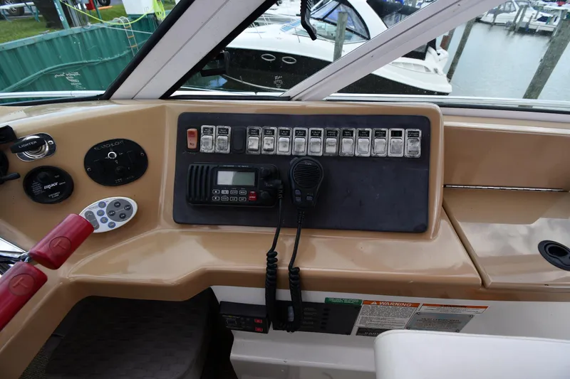 Slide: The Image of Control panel of a 2001 Carver 350 Mariner boat with switches and radio. - 21