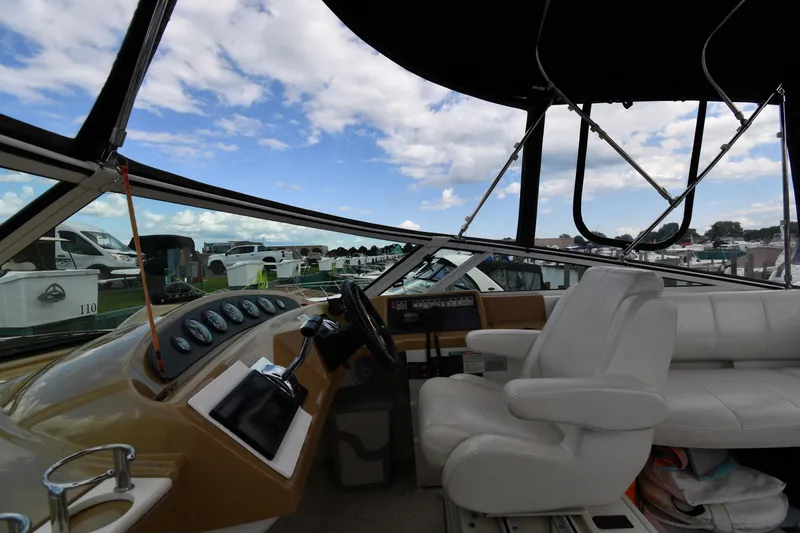 Slide: The Image of Interior view of 2001 Carver 350 Mariner yacht cockpit with white seating and control panel. - 22