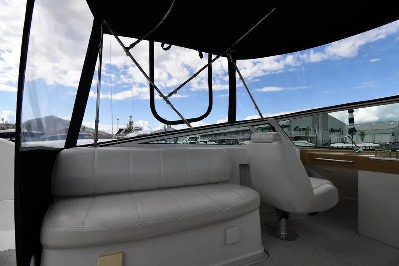 Slide: The Image of 2001 Carver 350 Mariner interior with white seating and marina view. - 24