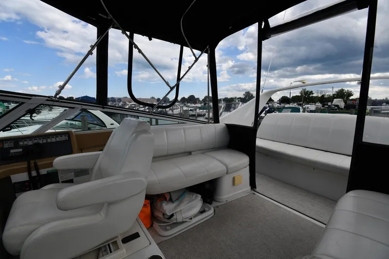 Slide: The Image of Interior of 2001 Carver 350 Mariner yacht with white seating and control panel. - 26