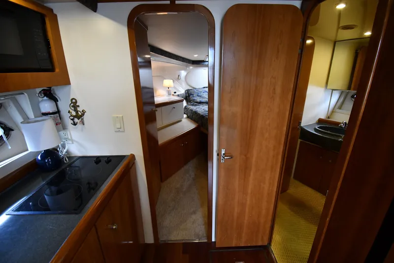 Slide: The Image of Interior of 2001 Carver 350 Mariner yacht featuring kitchen, bedroom, and bathroom. - 27
