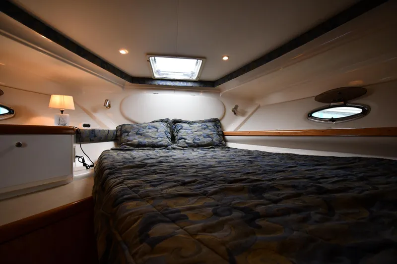 Slide: The Image of Cozy cabin interior of 2001 Carver 350 Mariner with bed and ambient lighting. - 28