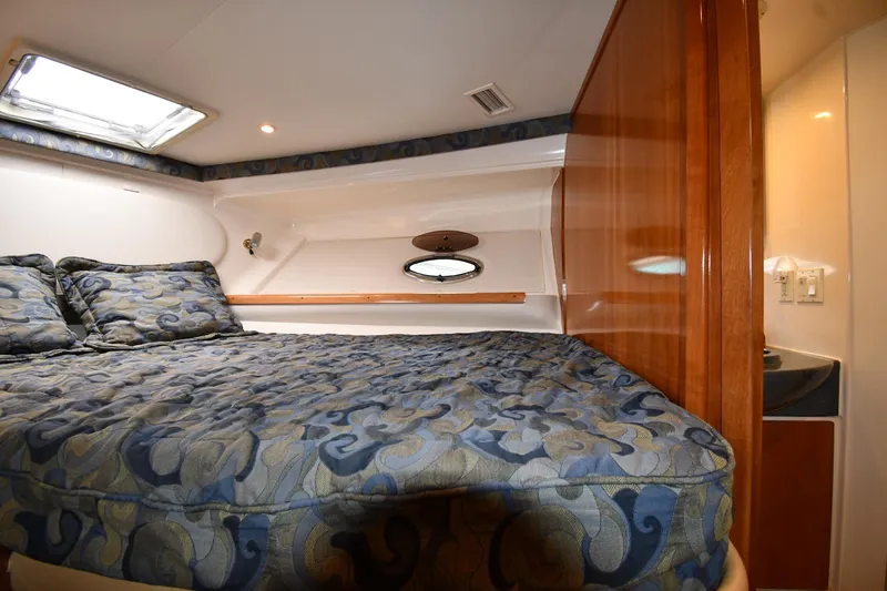 Slide: The Image of 2001 Carver 350 Mariner cabin interior with patterned bedding and wooden accents. - 29
