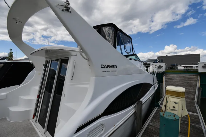 Slide: The Image of 2001 Carver 350 Mariner yacht docked at marina under cloudy sky. - 3