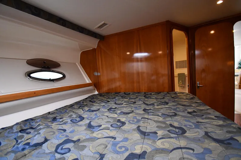 Slide: The Image of Interior cabin of 2001 Carver 350 Mariner yacht with patterned bedding and wood paneling. - 32