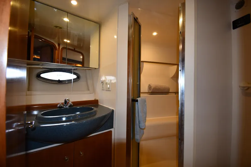 Slide: The Image of 2001 Carver 350 Mariner bathroom with sink, mirror, and shower area. - 34