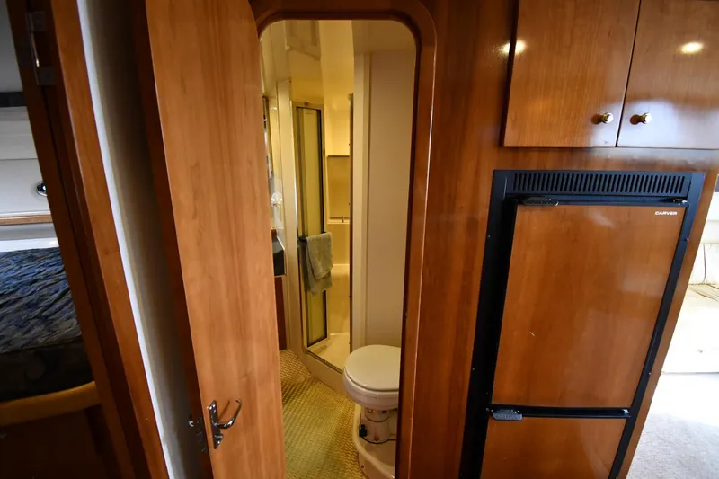 Slide: The Image of Interior of 2001 Carver 350 Mariner yacht showing bathroom and wooden cabinetry. - 35