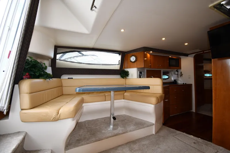 Slide: The Image of Interior of 2001 Carver 350 Mariner yacht with beige seating and modern amenities. - 38