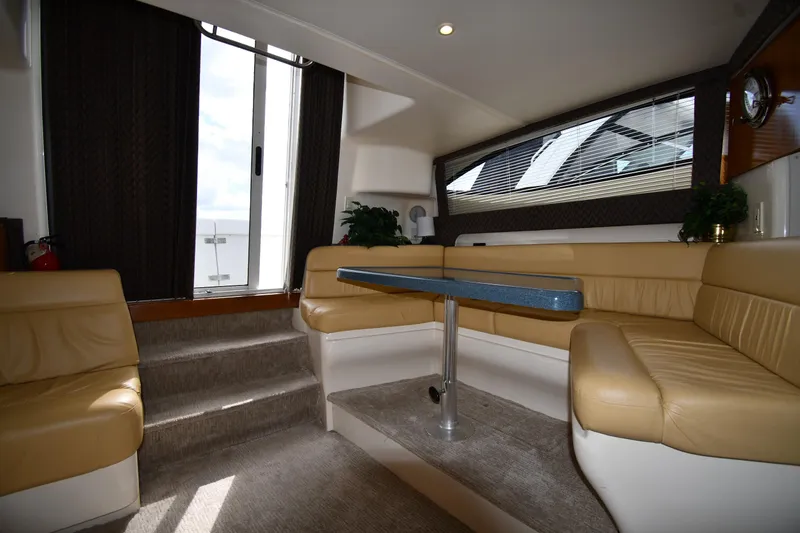 Slide: The Image of Interior of 2001 Carver 350 Mariner yacht with beige seating and table. - 39