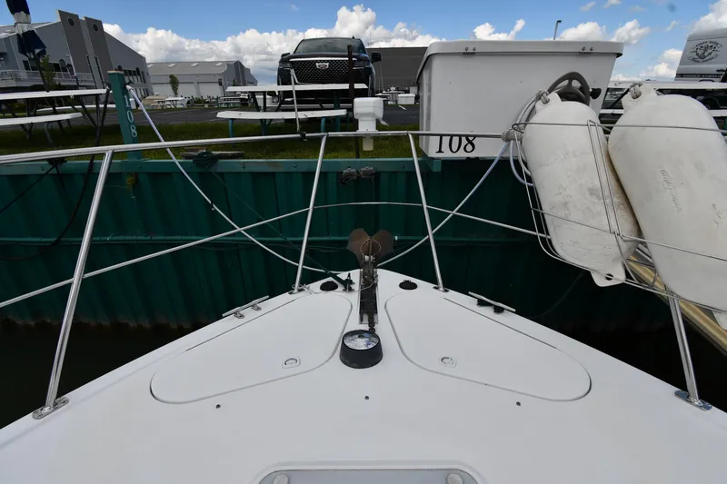 Slide: The Image of Bow view of 2001 Carver 350 Mariner docked, with fenders and marina background. - 4