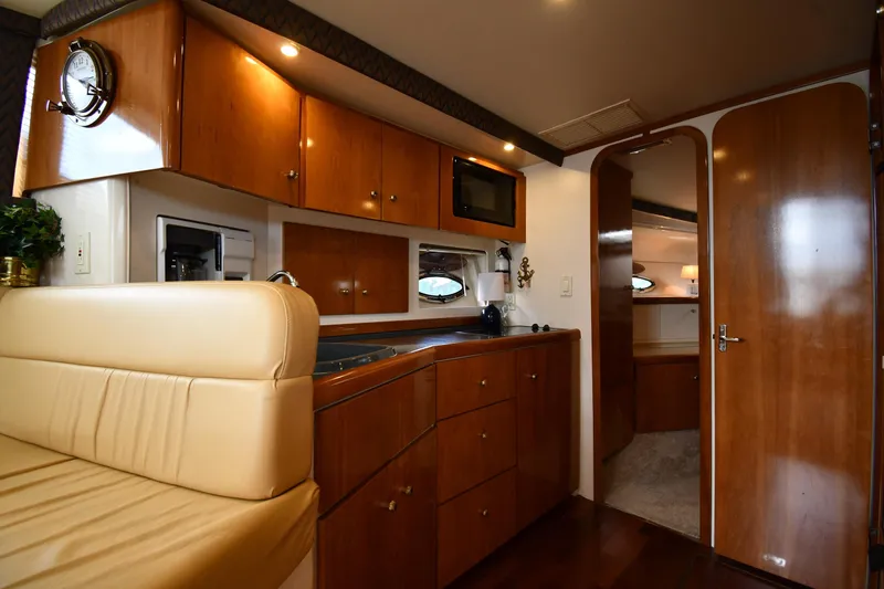 Slide: The Image of Interior of 2001 Carver 350 Mariner yacht, featuring wood cabinetry and modern amenities. - 41