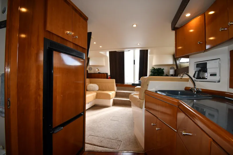Slide: The Image of 2001 Carver 350 Mariner interior with wood cabinetry, kitchenette, and seating area. - 43