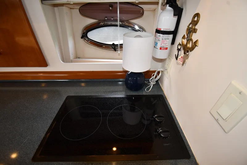 Slide: The Image of 2001 Carver 350 Mariner kitchen with stovetop, lamp, and fire extinguisher. - 45