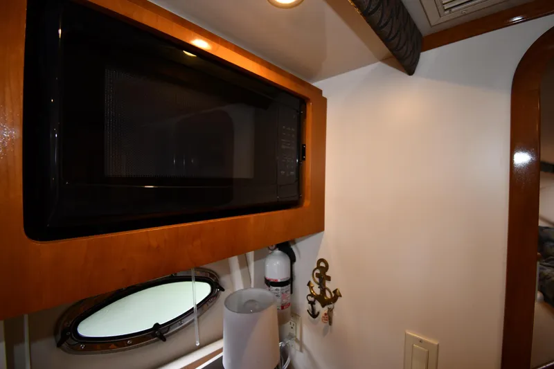 Slide: The Image of 2001 Carver 350 Mariner interior with microwave, porthole, and fire extinguisher. - 46