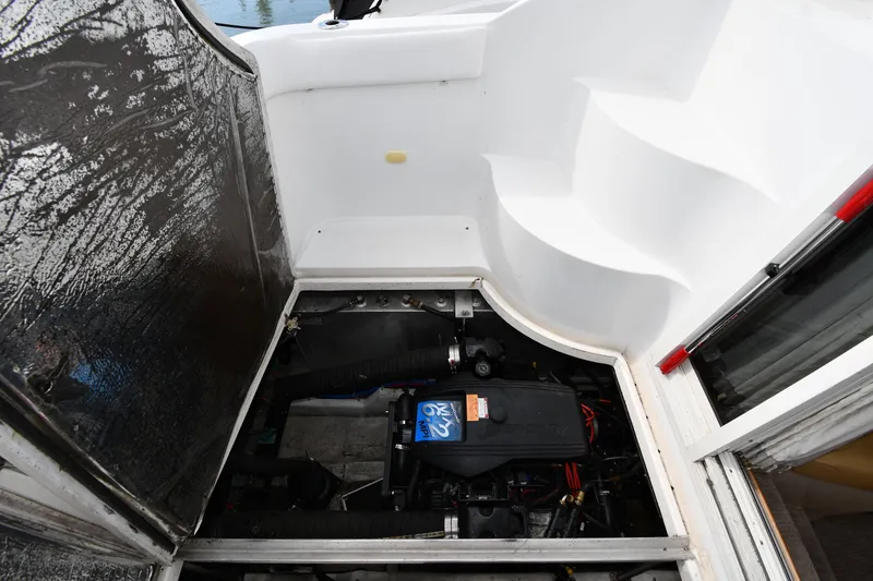 Slide: The Image of Engine compartment of a 2001 Carver 350 Mariner boat, showcasing mechanical components. - 49