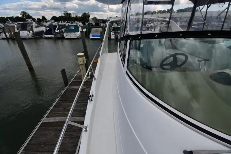 Slide: The Image of 2001 Carver 350 Mariner docked at marina, showcasing sleek design and spacious deck. - 7