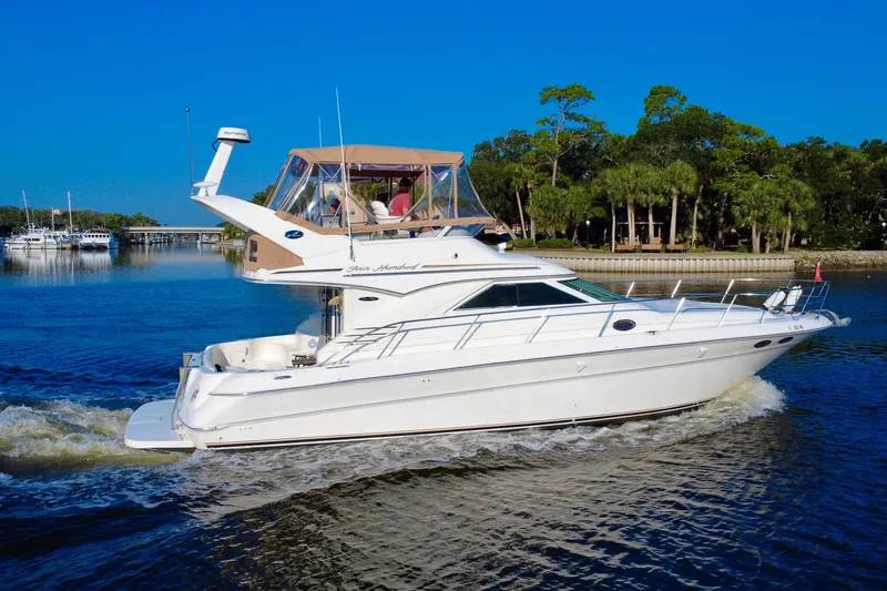 Slide: The Image of 2003 Sea Ray 400 Sedan Bridge yacht cruising on a sunny day. - 11