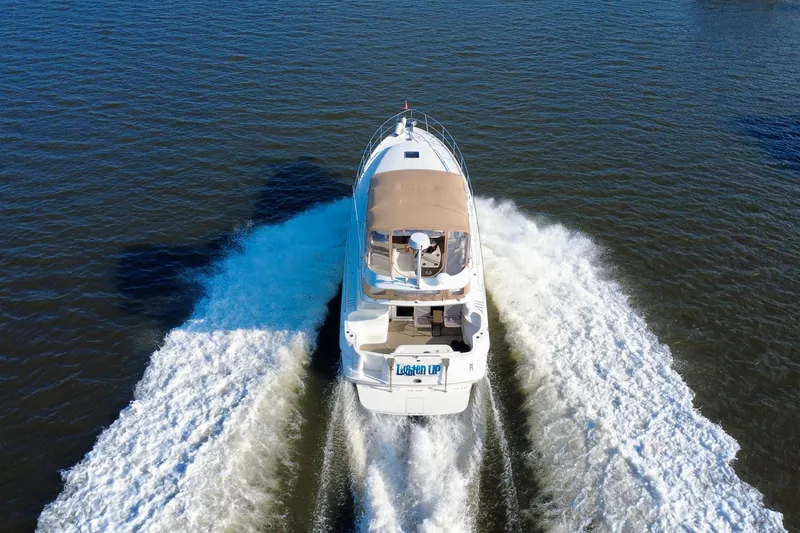 Slide: The Image of 2003 Sea Ray 400 Sedan Bridge cruising on open water, aerial rear view. - 14