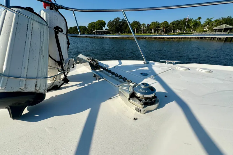 Slide: The Image of Bow deck of 2003 Sea Ray 400 Sedan Bridge with anchor winch and fenders. - 18