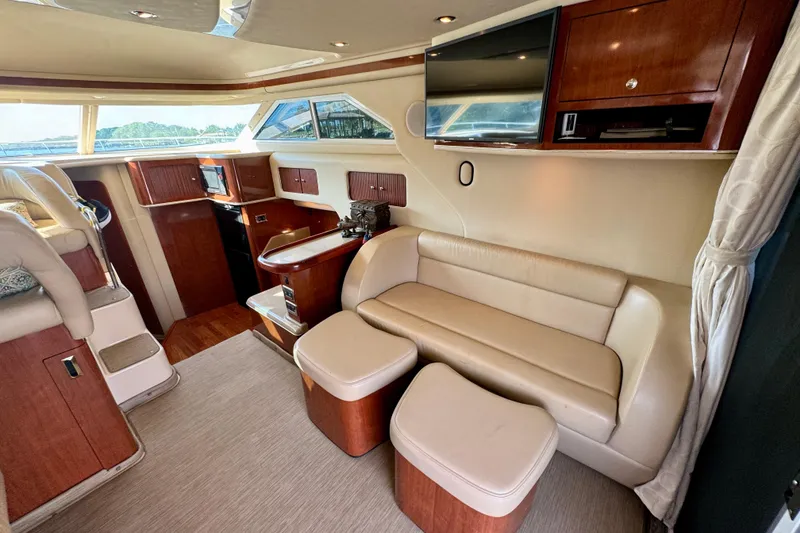 Slide: The Image of Luxurious interior of 2003 Sea Ray 400 Sedan Bridge yacht with leather seating and wood accents. - 22