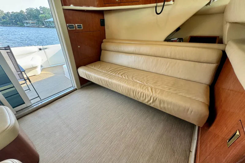 Slide: The Image of Interior of 2003 Sea Ray 400 Sedan Bridge with beige leather seating and lake view. - 23