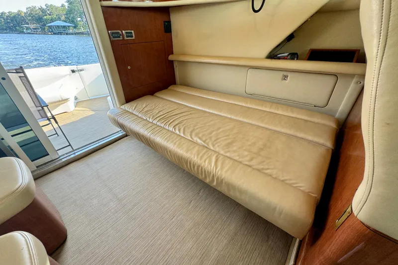 Slide: The Image of Interior of 2003 Sea Ray 400 Sedan Bridge with beige leather seating and lake view. - 24