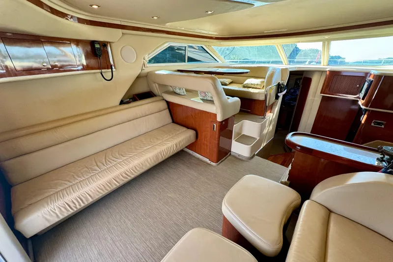 Slide: The Image of Luxurious interior of 2003 Sea Ray 400 Sedan Bridge yacht with plush seating and wood accents. - 25