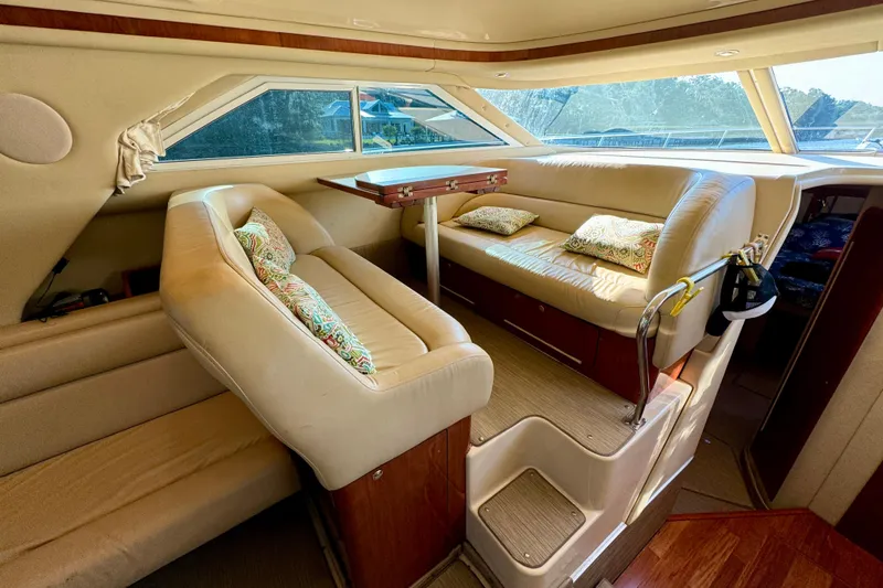 Slide: The Image of Luxurious interior of 2003 Sea Ray 400 Sedan Bridge with plush seating and elegant design. - 26