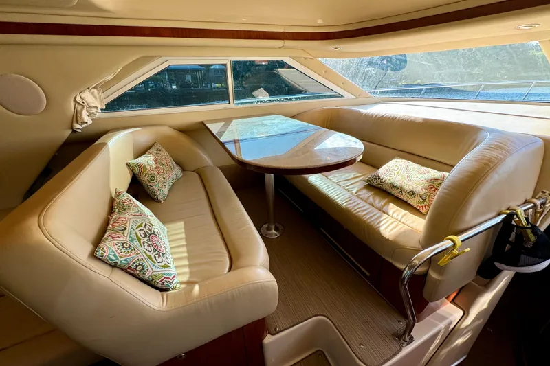 Slide: The Image of Luxurious interior of 2003 Sea Ray 400 Sedan Bridge with leather seating and decorative pillows. - 27