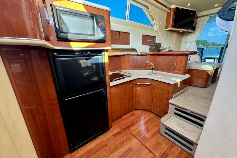 Slide: The Image of Luxurious 2003 Sea Ray 400 Sedan Bridge yacht interior with modern kitchen amenities. - 30