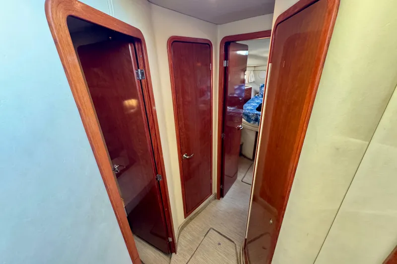 Slide: The Image of Interior hallway of 2003 Sea Ray 400 Sedan Bridge with wooden doors and cozy cabin. - 31