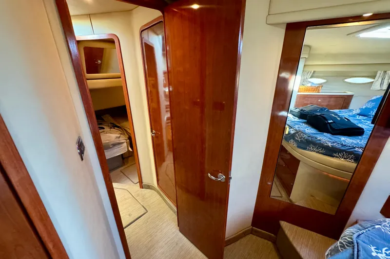 Slide: The Image of Interior of 2003 Sea Ray 400 Sedan Bridge, featuring wood finishes and cozy cabin spaces. - 32