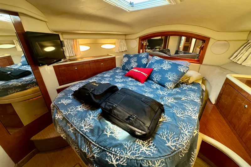 Slide: The Image of Luxurious cabin interior of 2003 Sea Ray 400 Sedan Bridge yacht with cozy bedding. - 33