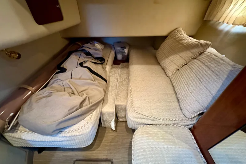 Slide: The Image of Interior cabin of 2003 Sea Ray 400 Sedan Bridge with cozy bedding and cushions. - 36