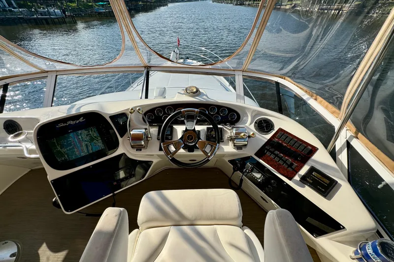 Slide: The Image of 2003 Sea Ray 400 Sedan Bridge helm with navigation controls and waterway view. - 43