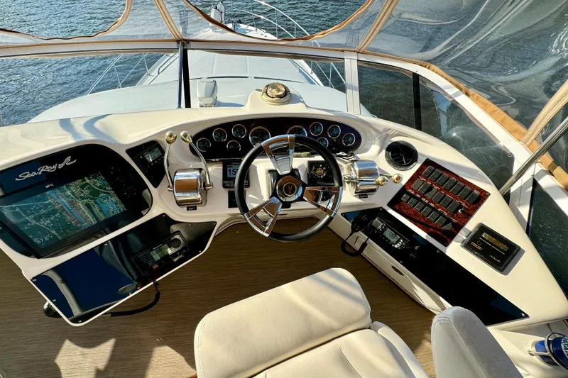 Slide: The Image of Helm of 2003 Sea Ray 400 Sedan Bridge with navigation controls and steering wheel. - 44
