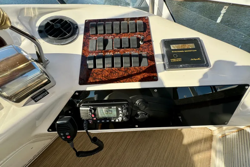 Slide: The Image of Control panel of a 2003 Sea Ray 400 Sedan Bridge yacht with switches and system monitor. - 48