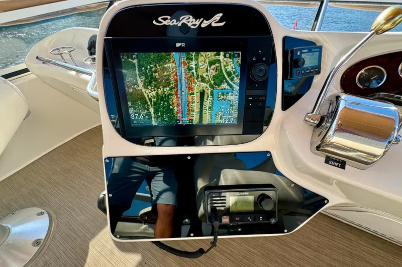 Slide: The Image of 2003 Sea Ray 400 Sedan Bridge helm with navigation display and controls. - 51