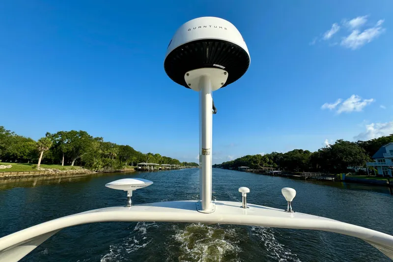 Slide: The Image of 2003 Sea Ray 400 Sedan Bridge cruising on a scenic river under a clear blue sky. - 54