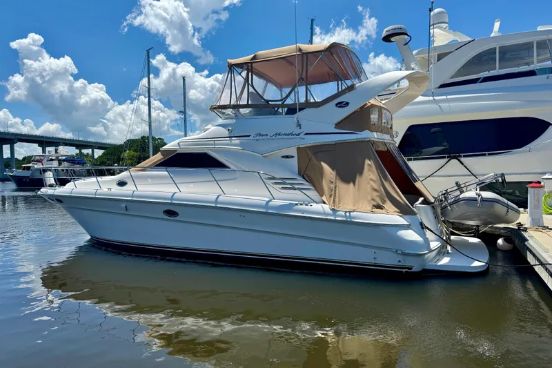 Slide: The Image of 2003 Sea Ray 400 Sedan Bridge yacht docked at marina under blue sky. - 56