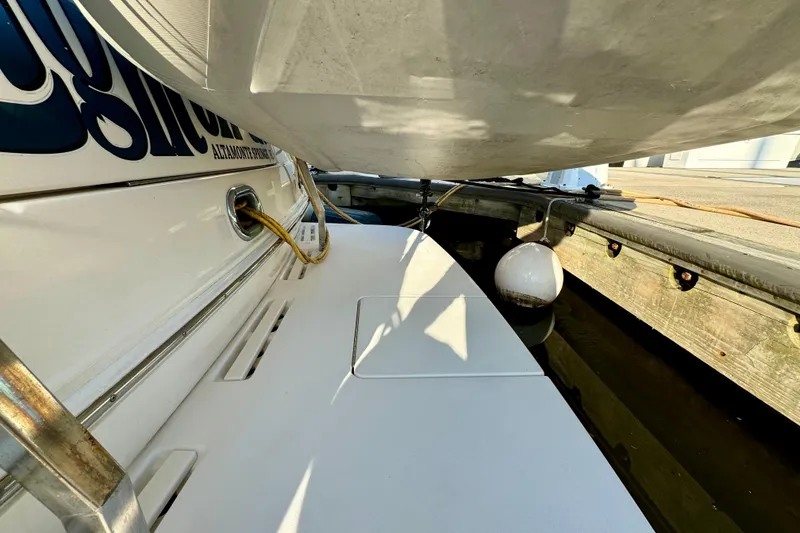 Slide: The Image of 2003 Sea Ray 400 Sedan Bridge docked, showing stern details and mooring setup. - 60