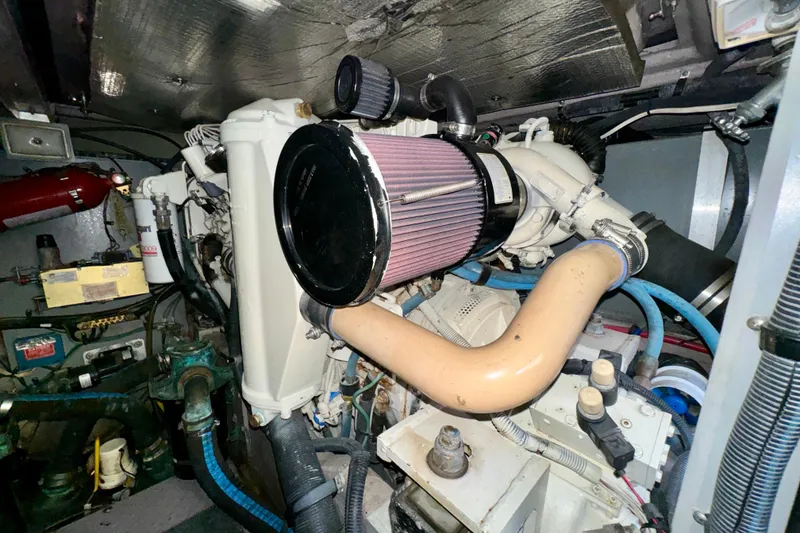 Slide: The Image of Engine room of a 2003 Sea Ray 400 Sedan Bridge with visible components and wiring. - 62