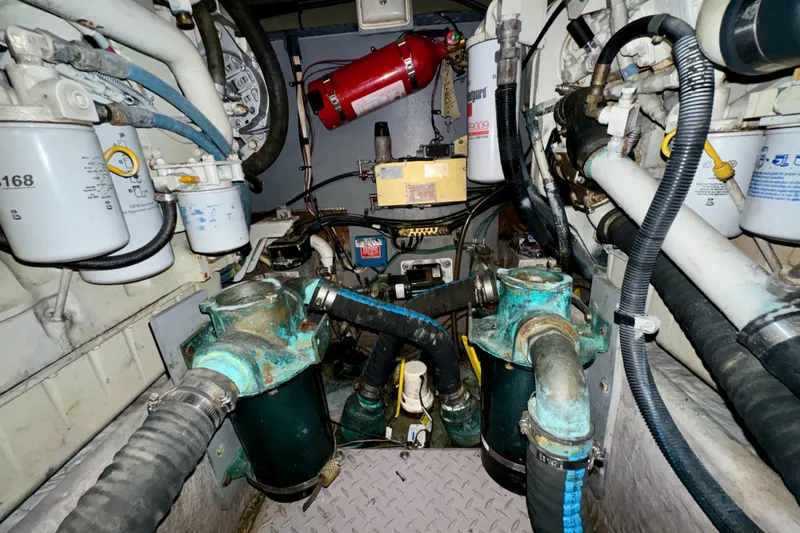 Slide: The Image of Engine room of 2003 Sea Ray 400 Sedan Bridge with visible filters and hoses. - 63