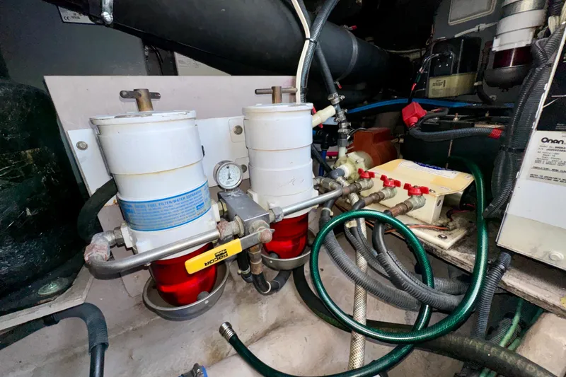 Slide: The Image of Engine room of 2003 Sea Ray 400 Sedan Bridge with fuel filters and hoses. - 64