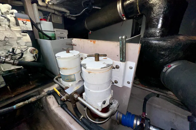 Slide: The Image of Engine room of 2003 Sea Ray 400 Sedan Bridge with fuel filters and piping. - 65