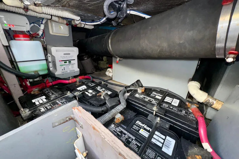 Slide: The Image of Engine room of 2003 Sea Ray 400 Sedan Bridge with batteries and wiring. - 67