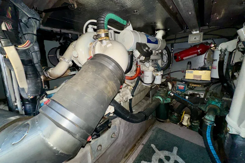 Slide: The Image of Engine room of a 2003 Sea Ray 400 Sedan Bridge, showcasing mechanical components. - 68