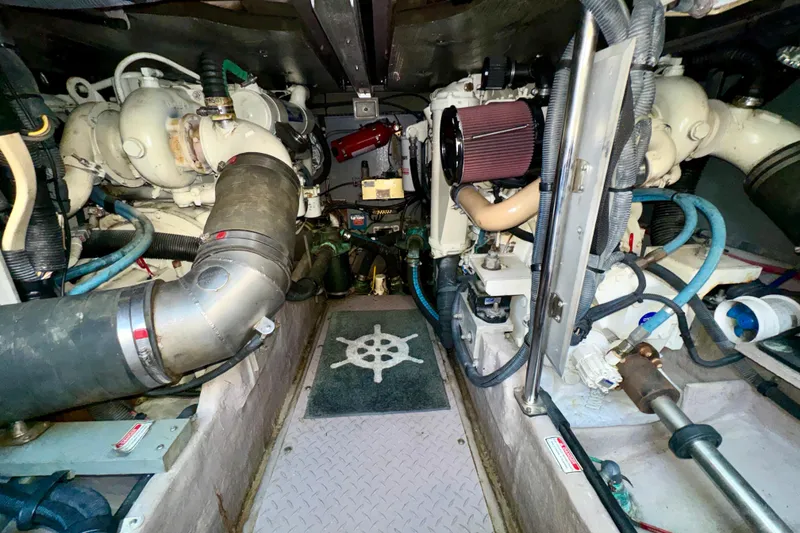 Slide: The Image of Engine room of a 2003 Sea Ray 400 Sedan Bridge yacht, showcasing mechanical components. - 69