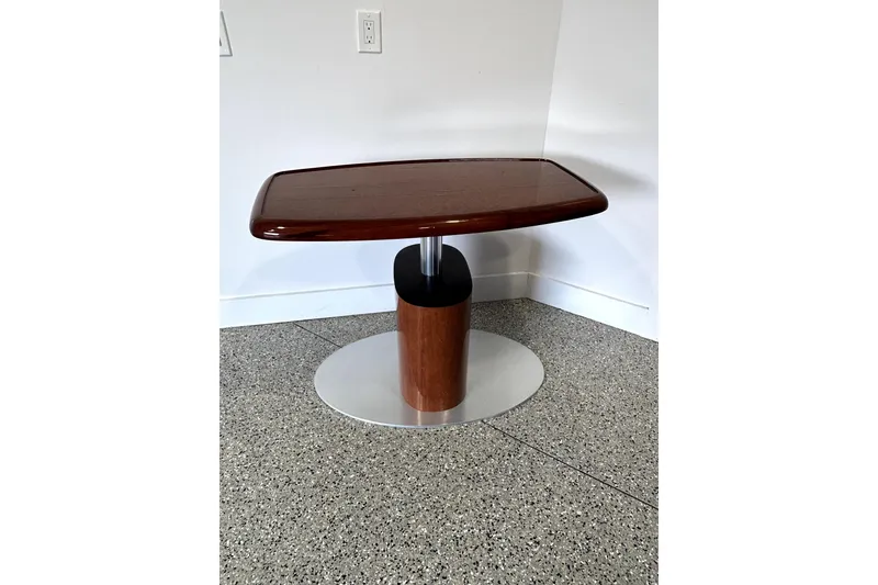 Slide: The Image of 2003 Sea Ray 400 Sedan Bridge wooden table with sleek design on speckled floor. - 70